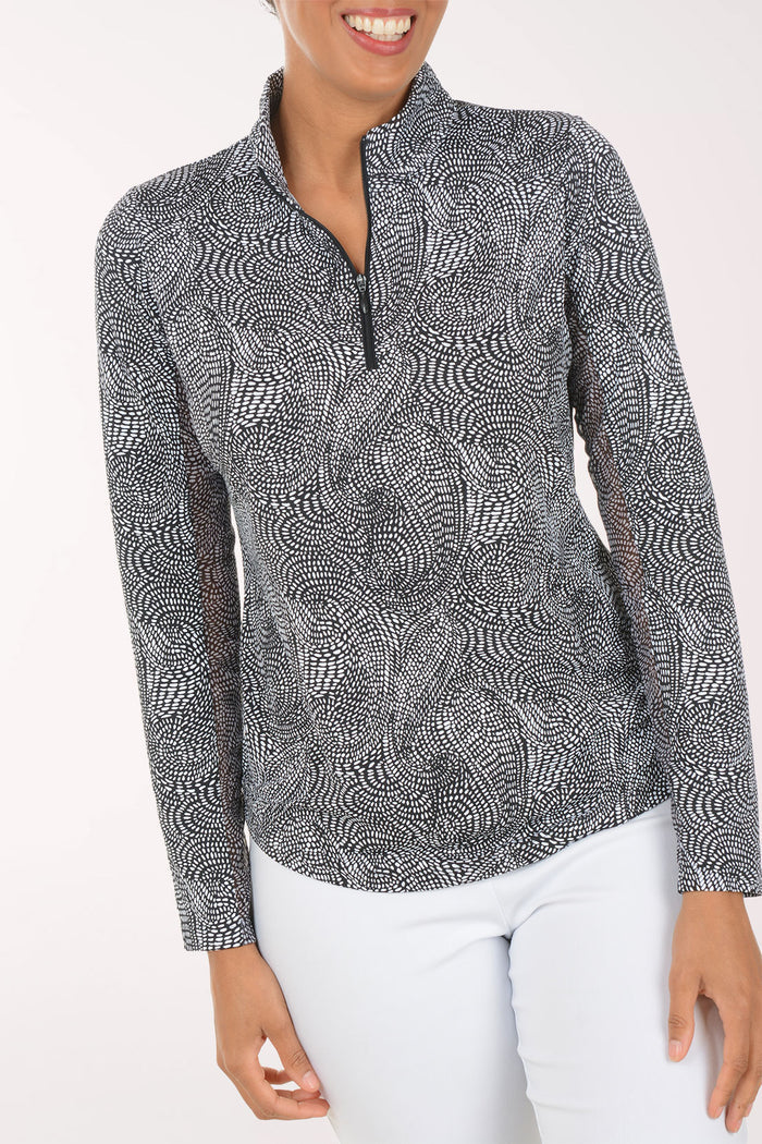 Woman wearing a patterned long-sleeve shirt on a white background