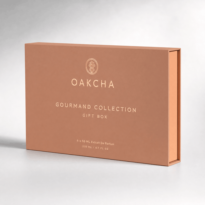 Three-quarter view of Gourmand Collection Gift Box Set showcasing a peach box with Oakcha logo and white GOURMAND COLLECTION text on a gray background
