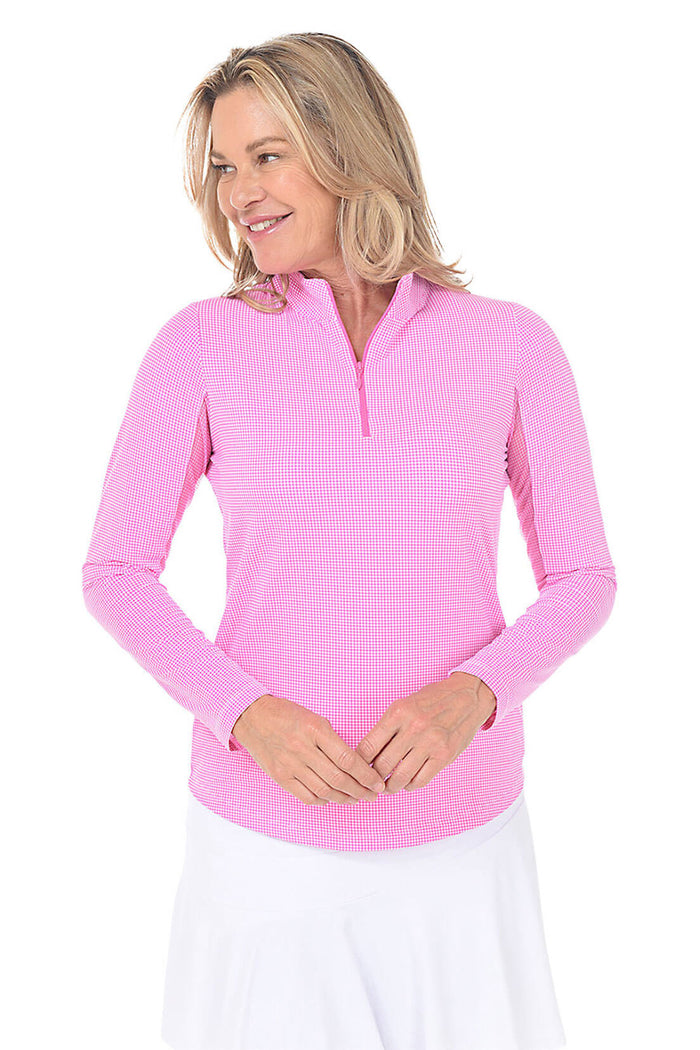 Woman wearing a pink long-sleeve top with a zipper on a white background