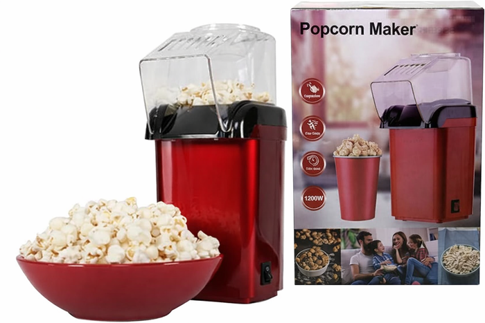 Red electric popcorn maker with clear lid and black front, with product box in view