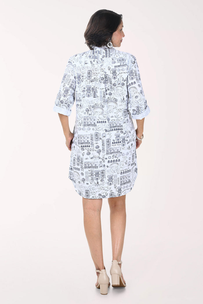 Woman wearing a white dress with black text pattern on a white background