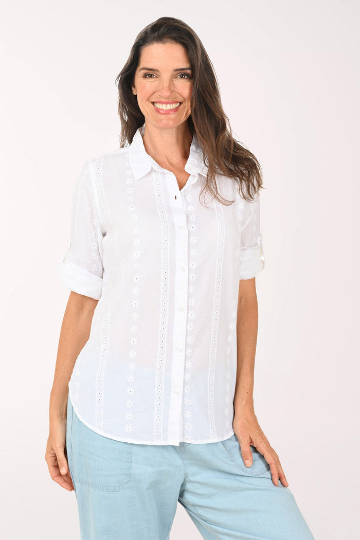Woman wearing a white roll sleeve top.