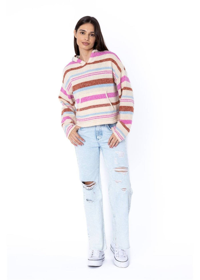 pose of Woman wearing a striped sweater and light blue jeans on a white background