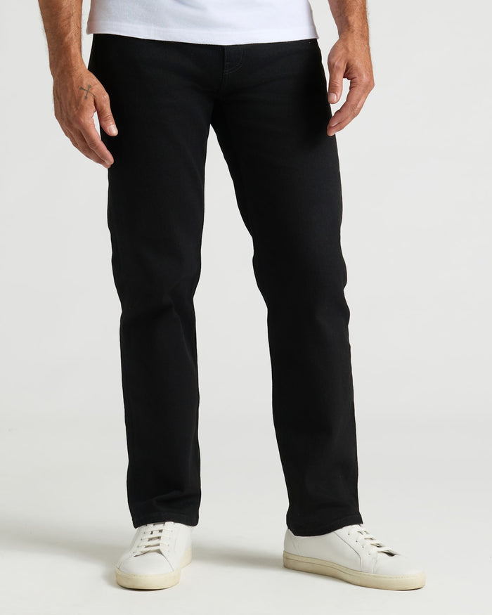 Black Wash Straight Authentic Denim Jeans with white sneakers and tattooed hand.