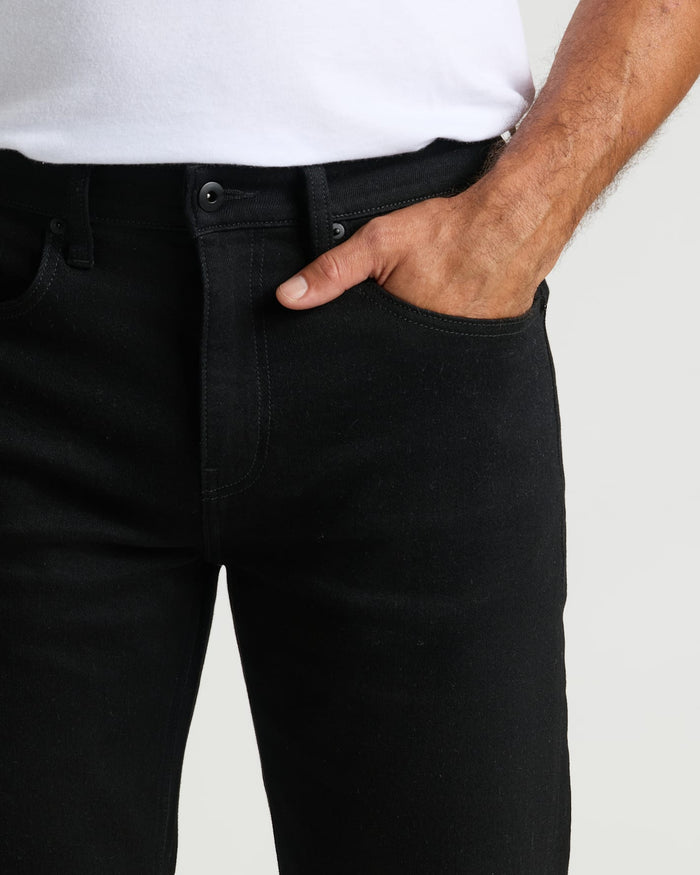 Black Wash Straight Authentic Denim Jeans with hand in pocket, showcasing fit.