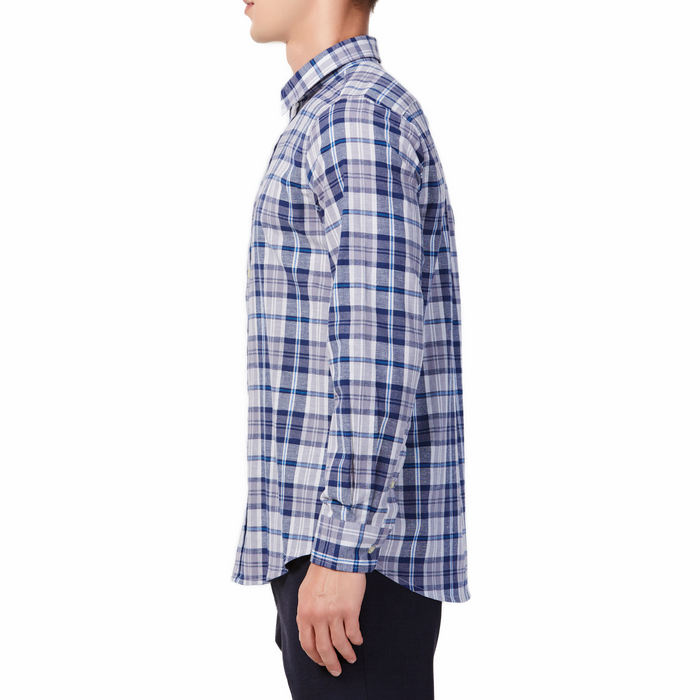 Men's blue and white plaid patterned,  long sleeve button up shirt with a pointed collar on a model. Image is cropped to the torso and model is facing to the side so the arm is facing the viewer