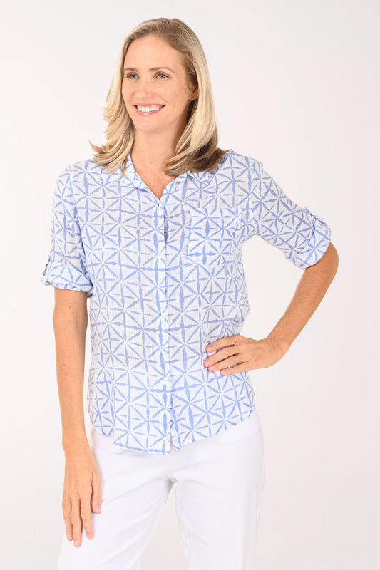 Woman wearing a blue and white button down top.