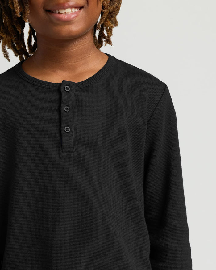 Boys Black Long Sleeve Waffle Henley worn by smiling youth.