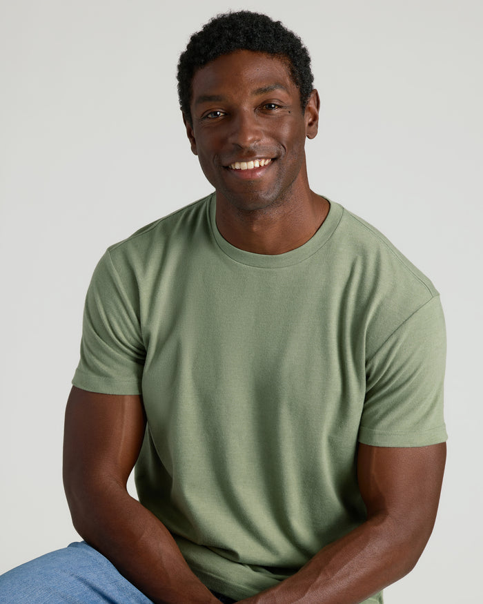 Young man in Dark Heather Bay Green Classic Crew Neck.