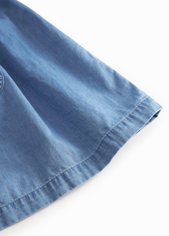 Blue children's dress with puff sleeves, pockets, and a button closure.