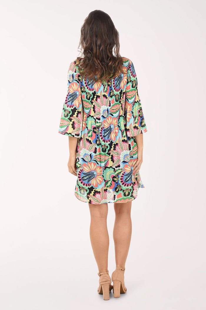 Woman wearing a colorful floral dress on a white background
