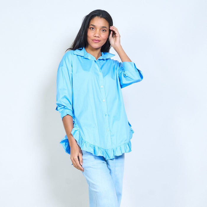 Flowy button-front shirt with ruffled hem detail and classic collar wholesale