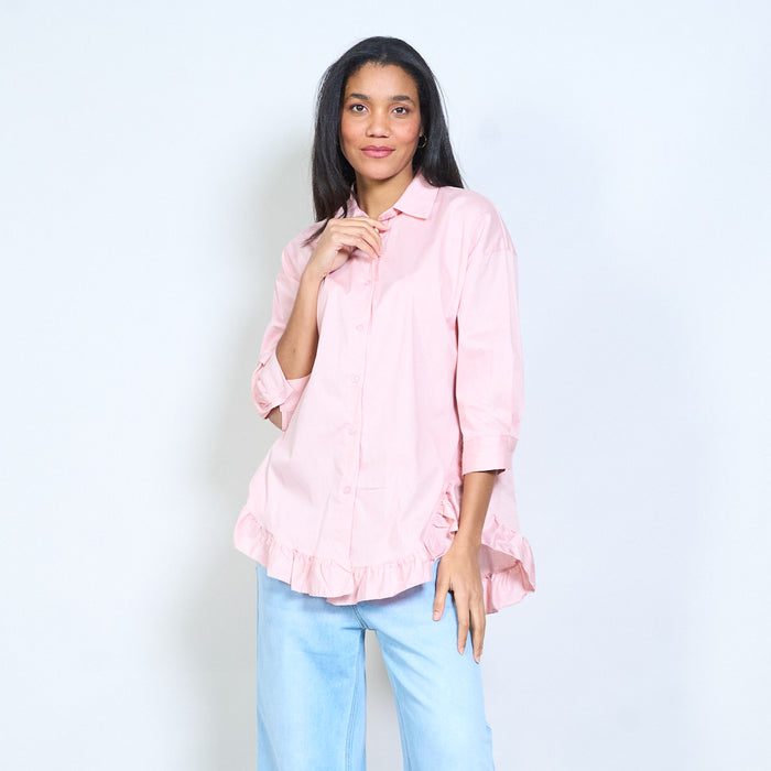 Flowy button-front shirt with ruffled hem detail and classic collar wholesale