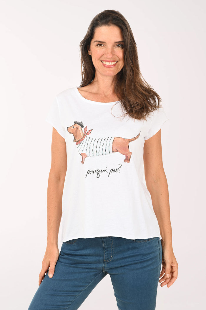Woman wearing a white t-shirt with dog design on a plain background