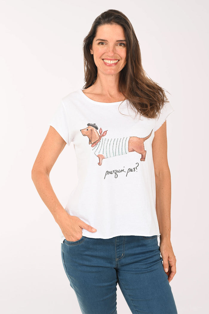 Woman wearing a white t-shirt with dog design on a plain background