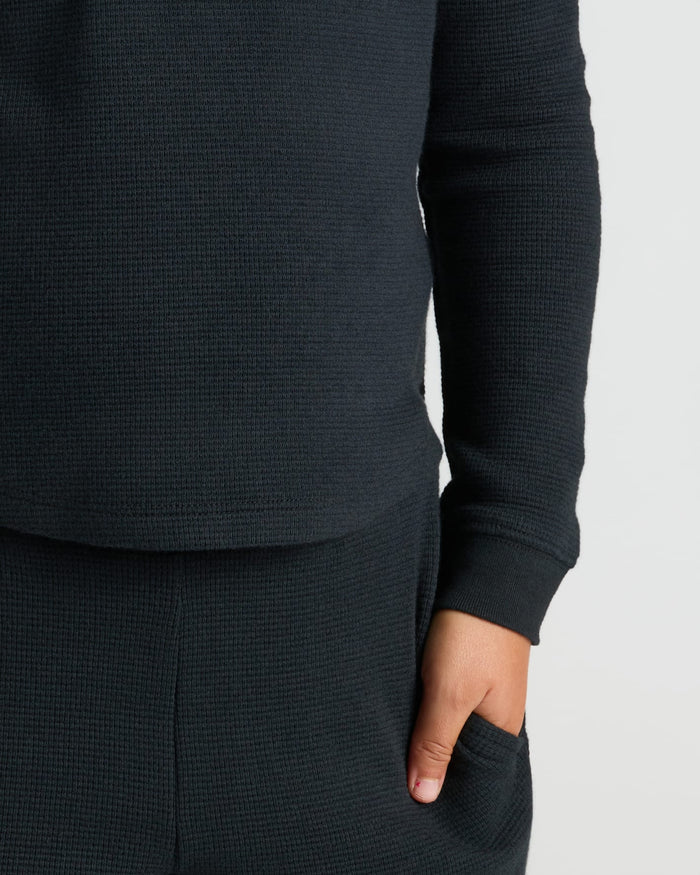 Girls Long Sleeve Boxy Waffle Henley, cozy waffle-knit texture, hand in pocket.