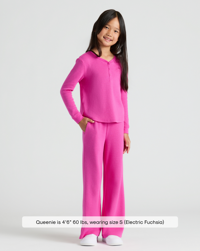 Girl models Girls Electric Fuchsia Long Sleeve Boxy Waffle Henley and pants.