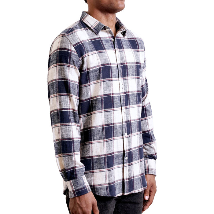 three quarters side view of men's long sleeve, tailored, blue and cream plaid flannel button up shirt on a black model.