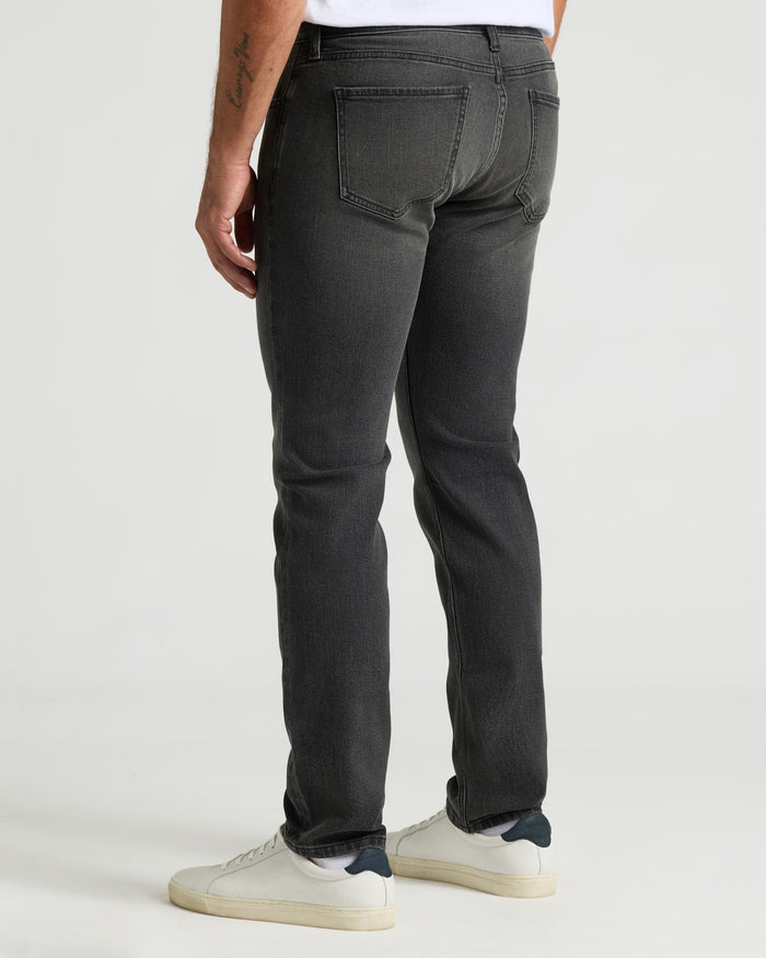 Gray Wash Slim Authentic Denim Jeans styled with white low-top sneakers.