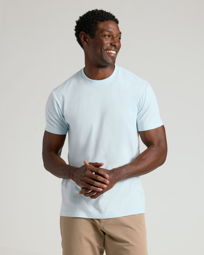Man in Classic Crew Neck T-shirt, smiling confidently.