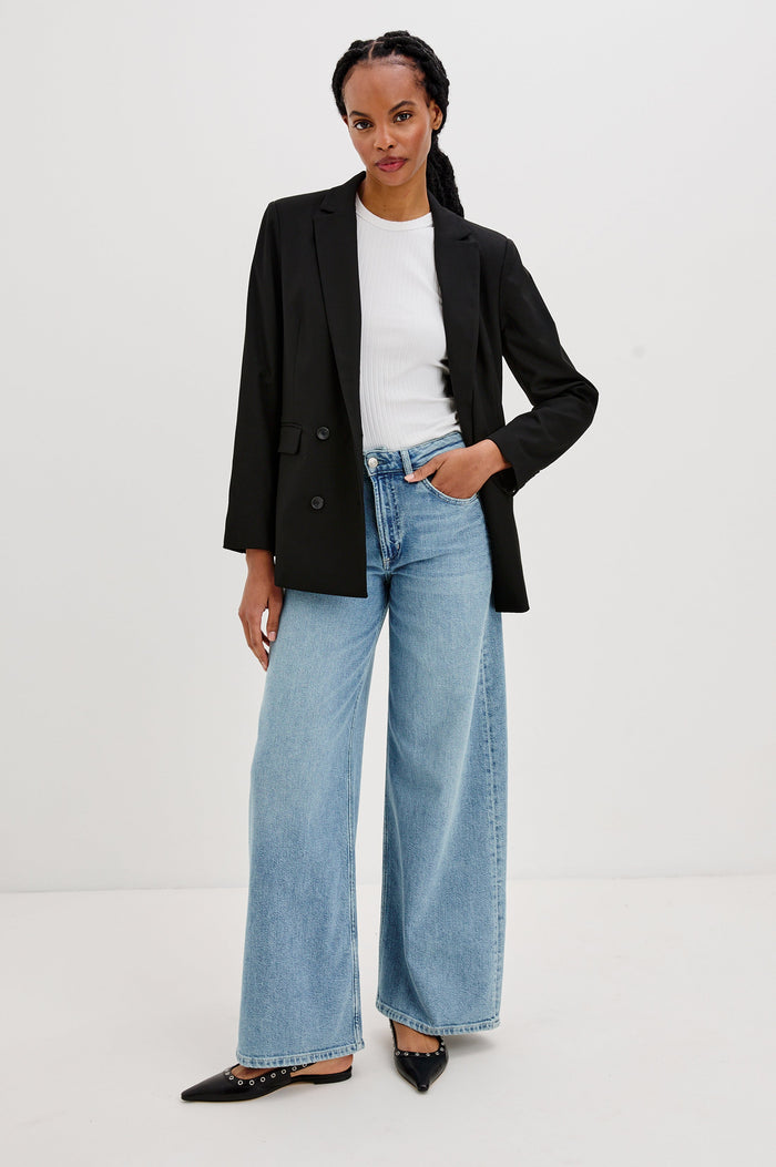 Jac Double-Breasted Blazer with Two Front Flap Pockets and a Notched Label in Black Twill Colorway - Front Full Body View Featured on Model