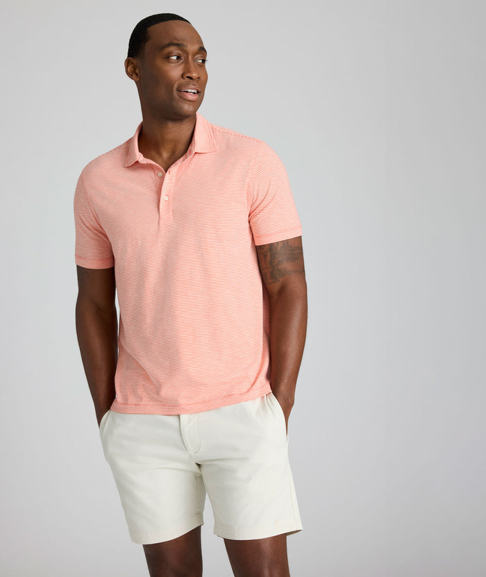 Model is wearing UNTUCKit Belvoir polo in emberglow.