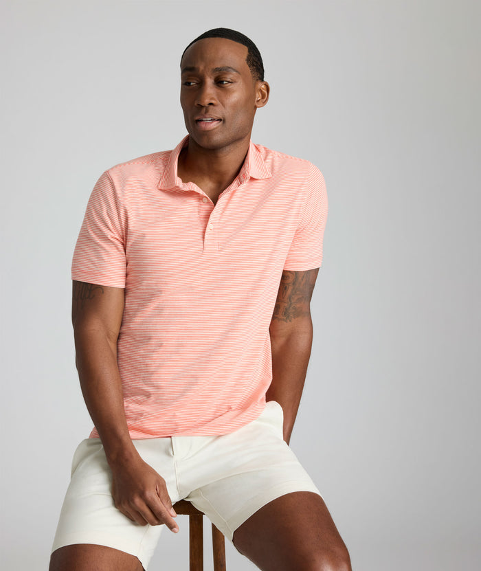 Model is wearing UNTUCKit Belvoir polo in emberglow.
