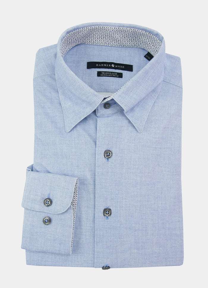 Folded Lamson light blue dress shirt with a spread collar and black buttons, featuring a visible brand label inside the collar.