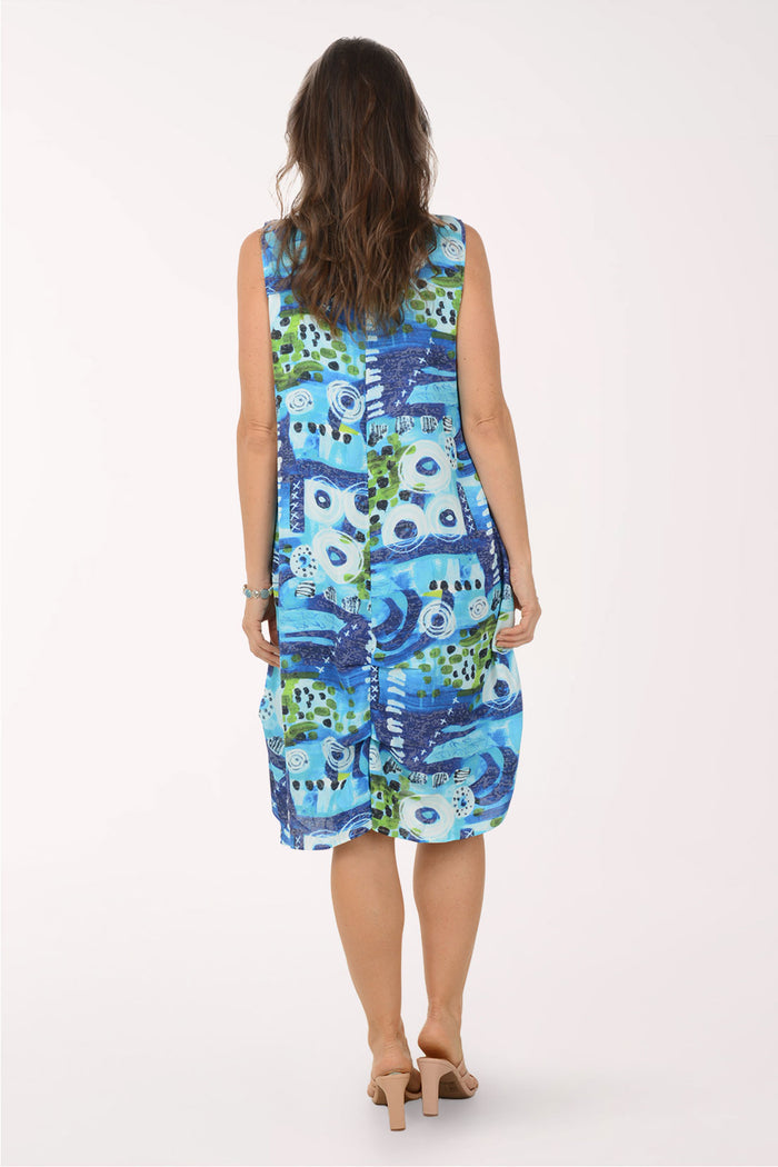 Woman wearing a blue and green patterned dress on a white background