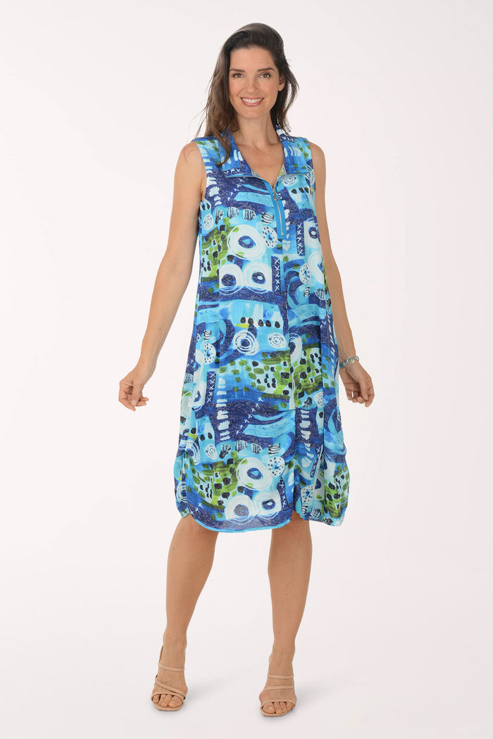 Woman wearing a blue and green patterned dress on a white background