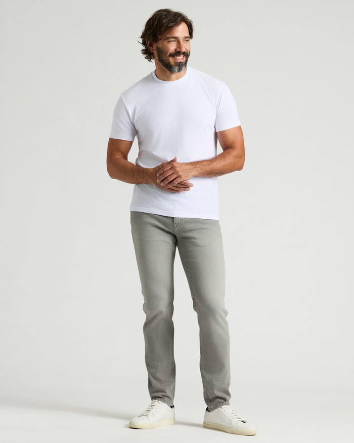 Man in Medium Gray Wash Slim Authentic Denim Jeans.