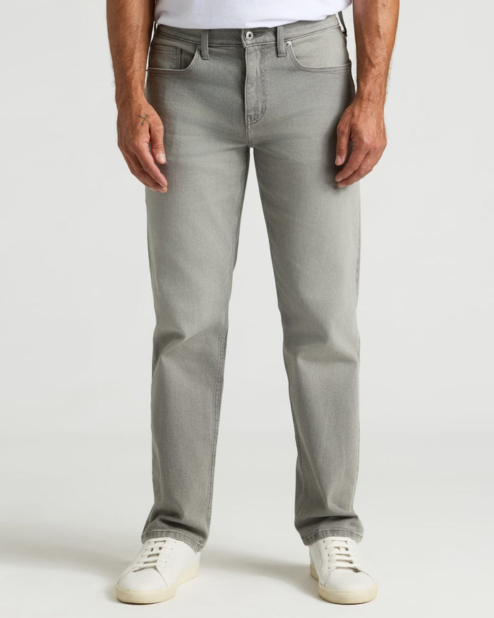 Medium Gray Wash Straight Authentic Denim Jeans with white sneakers.