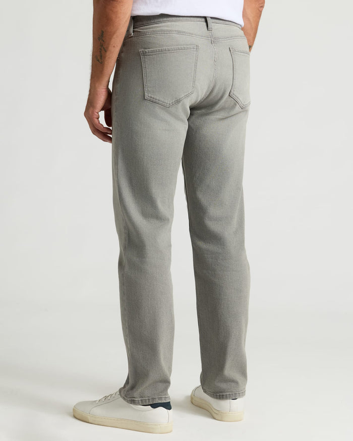 Medium Gray Wash Straight Authentic Denim Jeans styled with white sneakers.