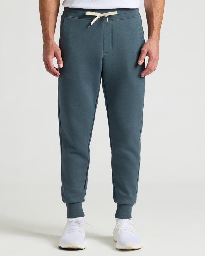 Neptune Fleece French Terry Joggers modeled with white sneakers.