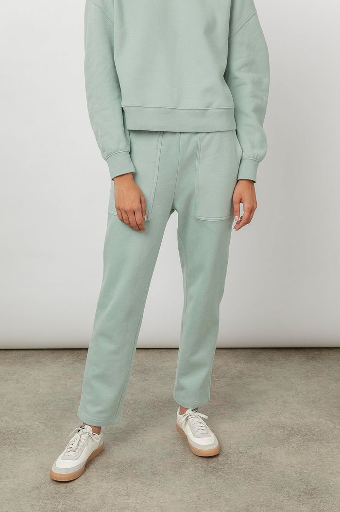 Nico & Edna Set with a Sweatshirt with a Hood and Pants with Two Large Front Pockets and One Back Patch Pocket in Light Seafoam Colorway - Front View Featured on Model