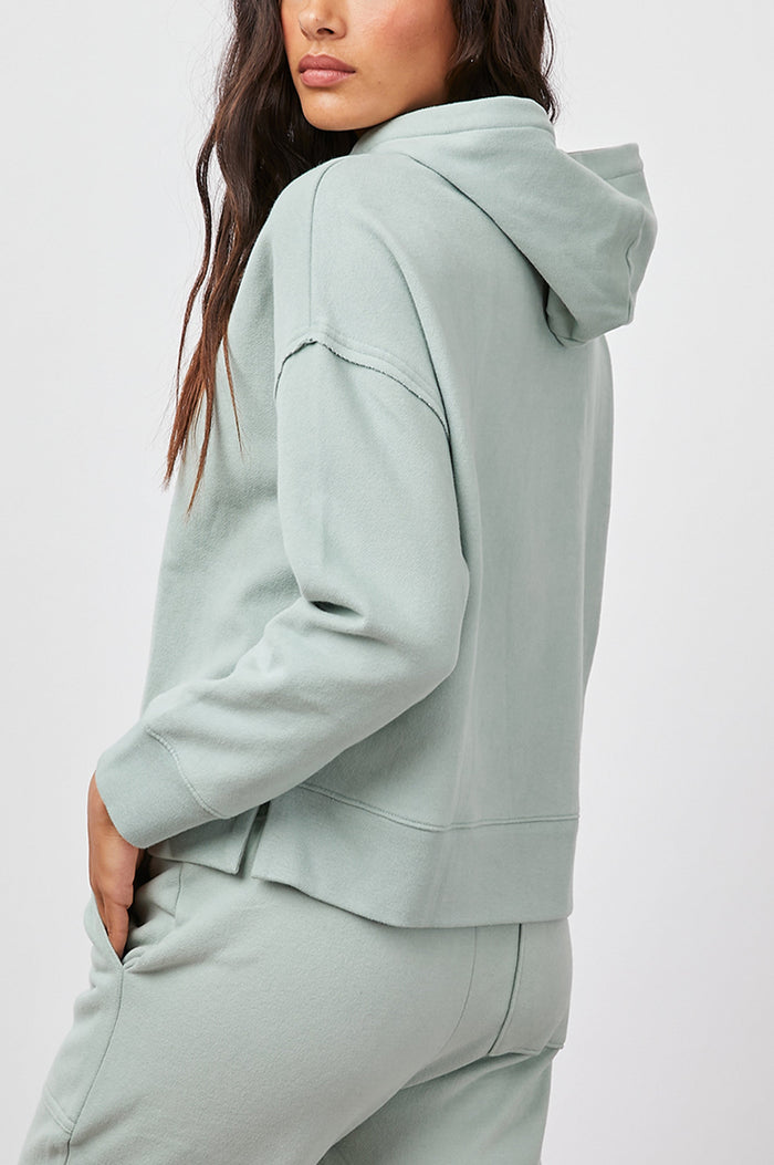 Nico & Edna Set with a Sweatshirt with a Hood and Pants with Two Large Front Pockets and One Back Patch Pocket in Light Seafoam Colorway - Side View Featured on Model