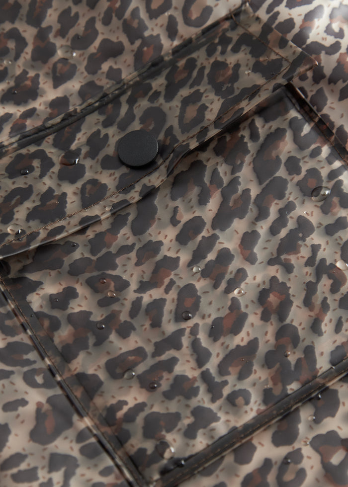 Close-up of the front pocket of a leopard-print rain jacket