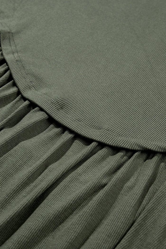 Close-up of olive green fabric texture and stitching on casual plus size long sleeve blouse