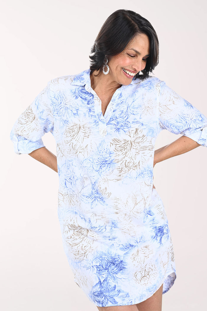 Woman wearing a blue and white patterned dress on a white background