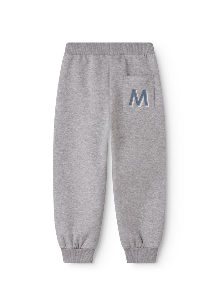 Gray jogging pants with elastic waist and 'M' logo on the right leg.