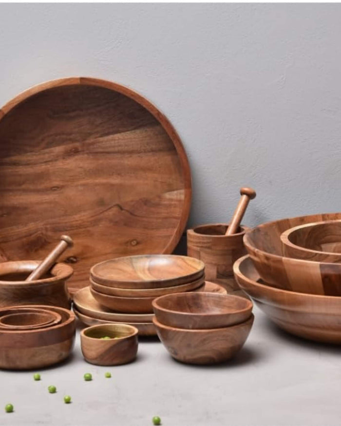 Round wooden soup bowls with serving spoons, assorted bowl sizes on table