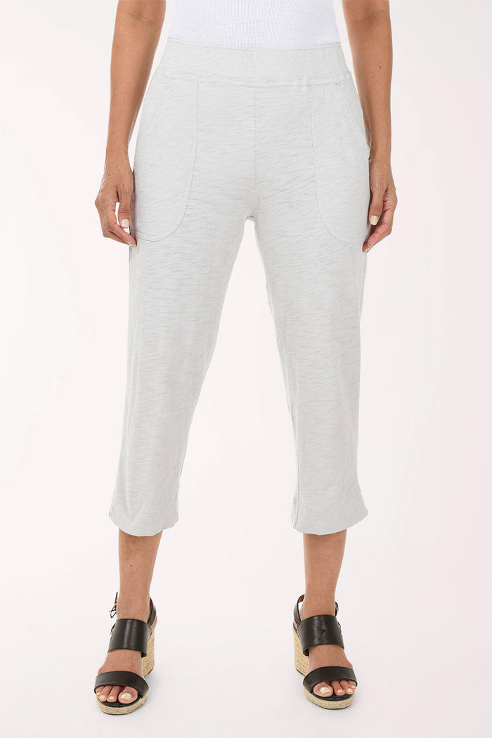 Person wearing light grey pants on a white background