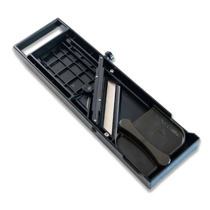 A black Quirelois Japanese Mandoline underside with a stainless steel blade and adjustment knob.