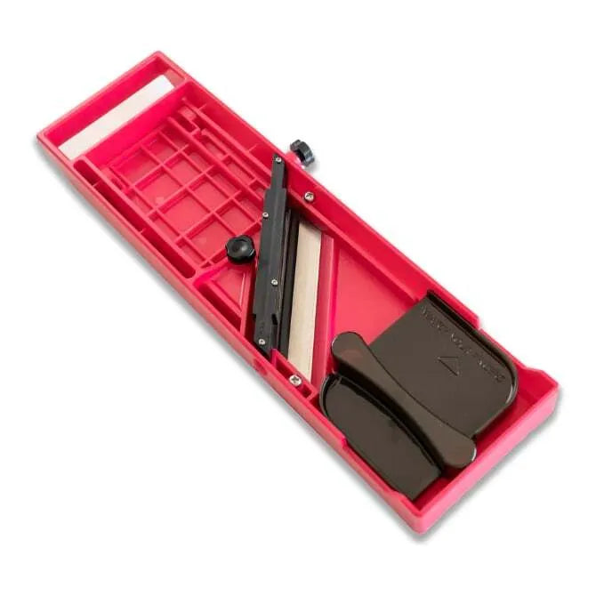 A red Quirelois Japanese Mandoline underside with a stainless steel blade and adjustment knob.