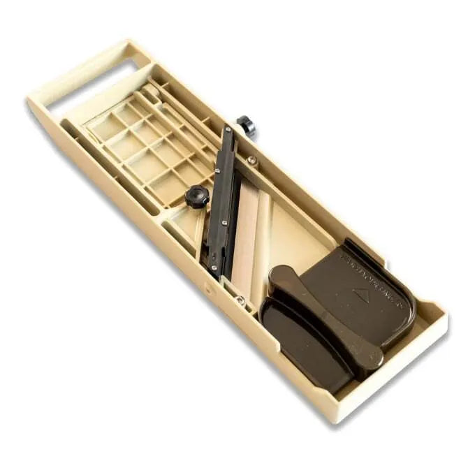 A sand colered Quirelois Japanese Mandoline underside with a stainless steel blade and adjustment knob.