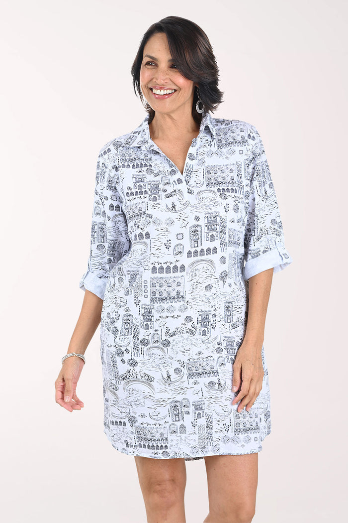 Woman wearing a white dress with black text pattern on a white background