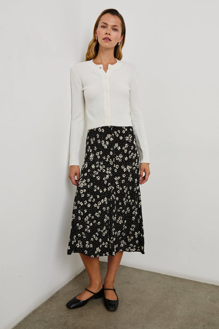 Rosetta Midi Skirt with Buttons Down the Front in Noir Floral Colorway, white flowers on black - Front Full Body View Featured on Model