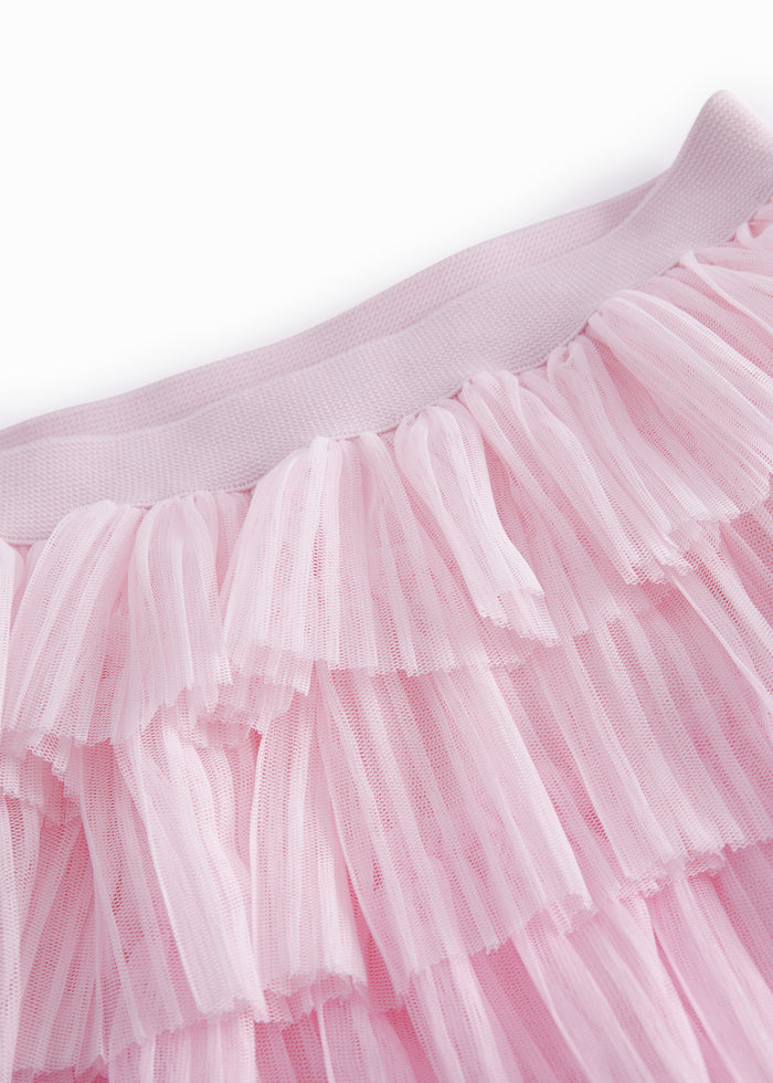 Red lower part for children in light, pleated tyl with multiple layers.