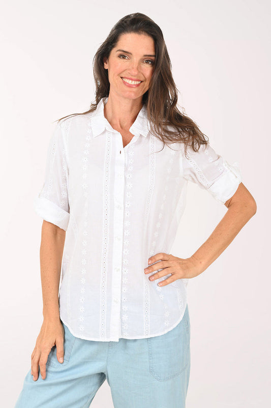Woman wearing a white roll sleeve top.