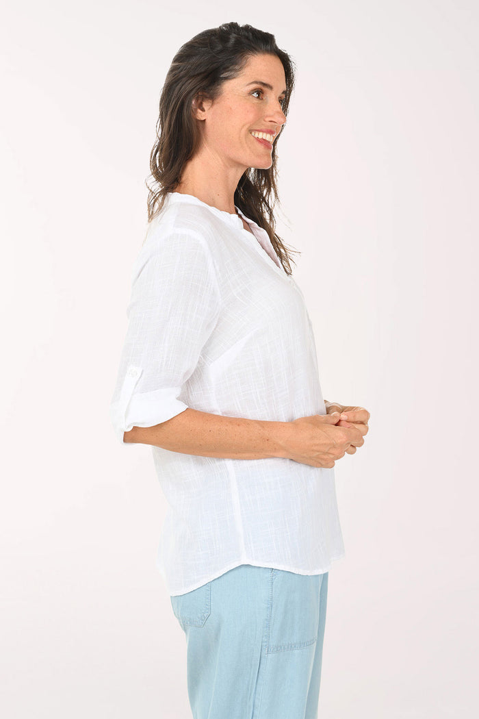 Woman wearing a 3/4 roll sleeve white blouse